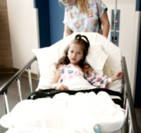 Photograph of a girl in a hospital bed